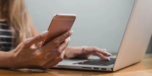 Woman Hands Using Phone Laptop Min